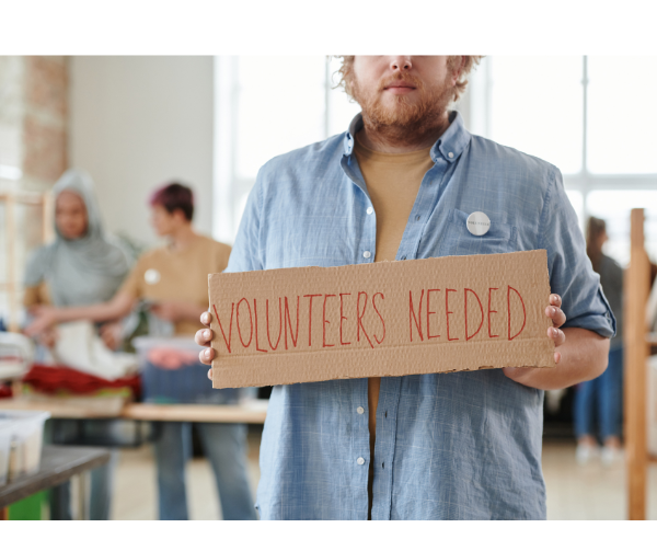 Whitney leaning against a railing on a downtown street