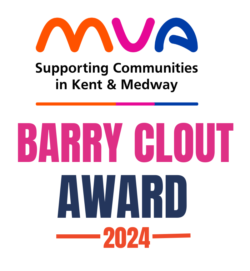 Whitney leaning against a railing on a downtown street