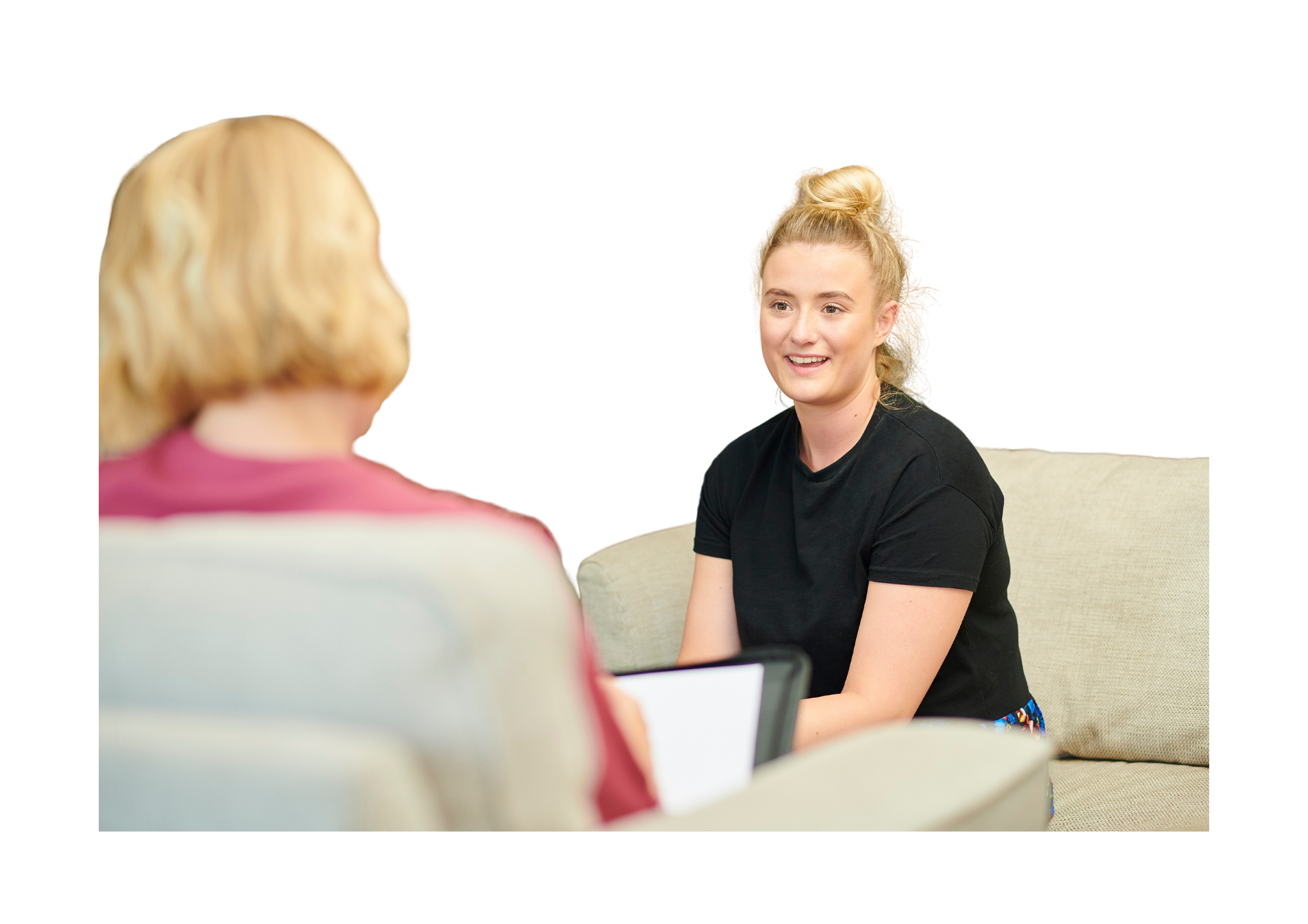 Whitney leaning against a railing on a downtown street