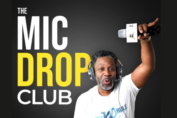 Whitney leaning against a railing on a downtown street