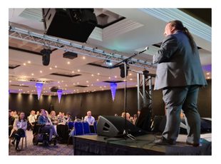 Whitney leaning against a railing on a downtown street