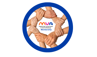 Whitney leaning against a railing on a downtown street