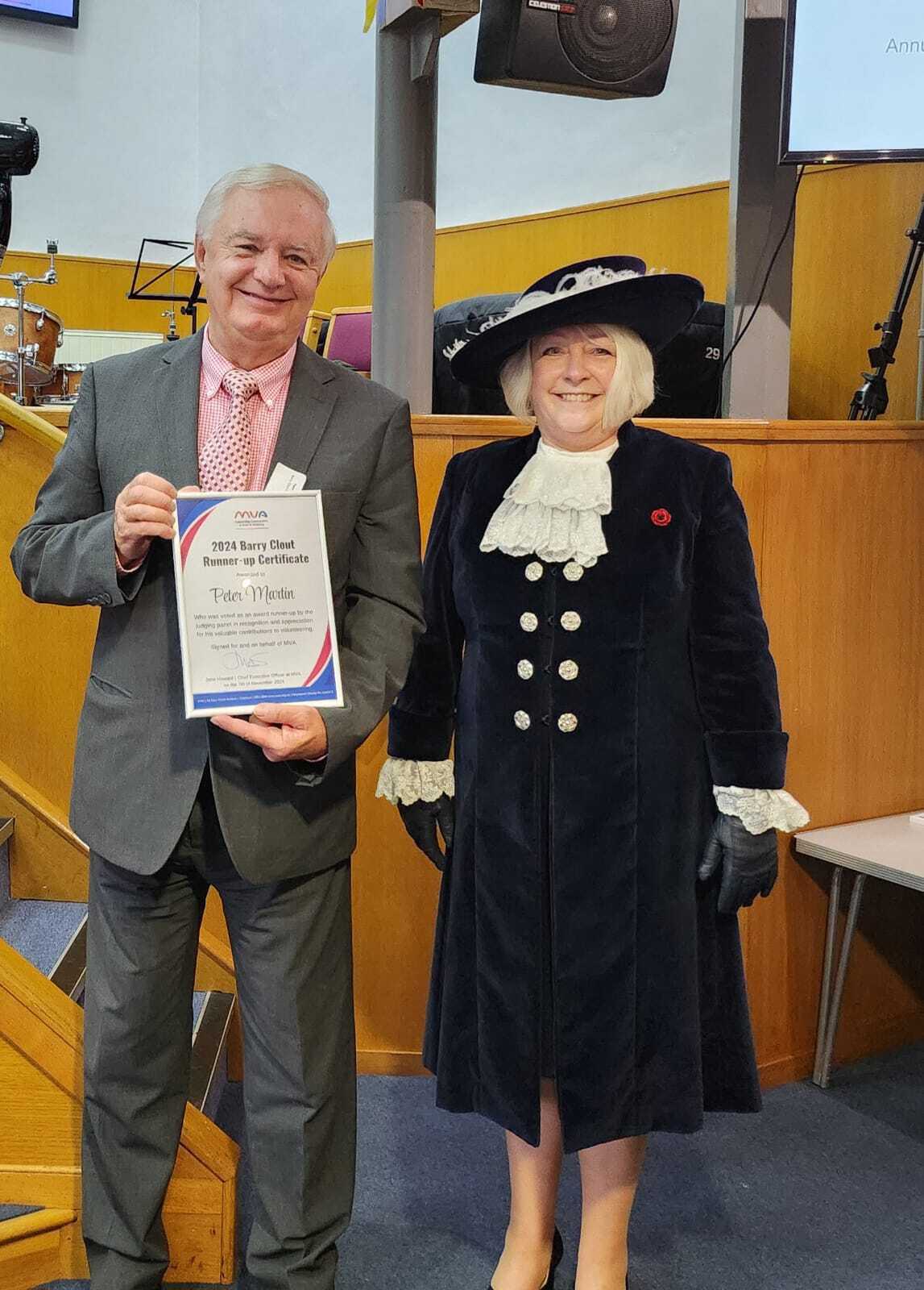 Whitney leaning against a railing on a downtown street